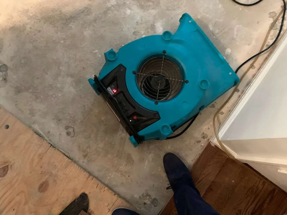 Air mover drying subfloor during Commercial Water Damage Restoration in Gary
